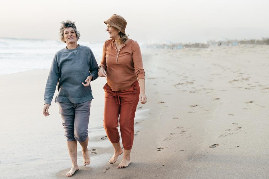 Two women walking on the beach