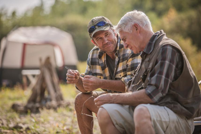 A younger man talking to an older man